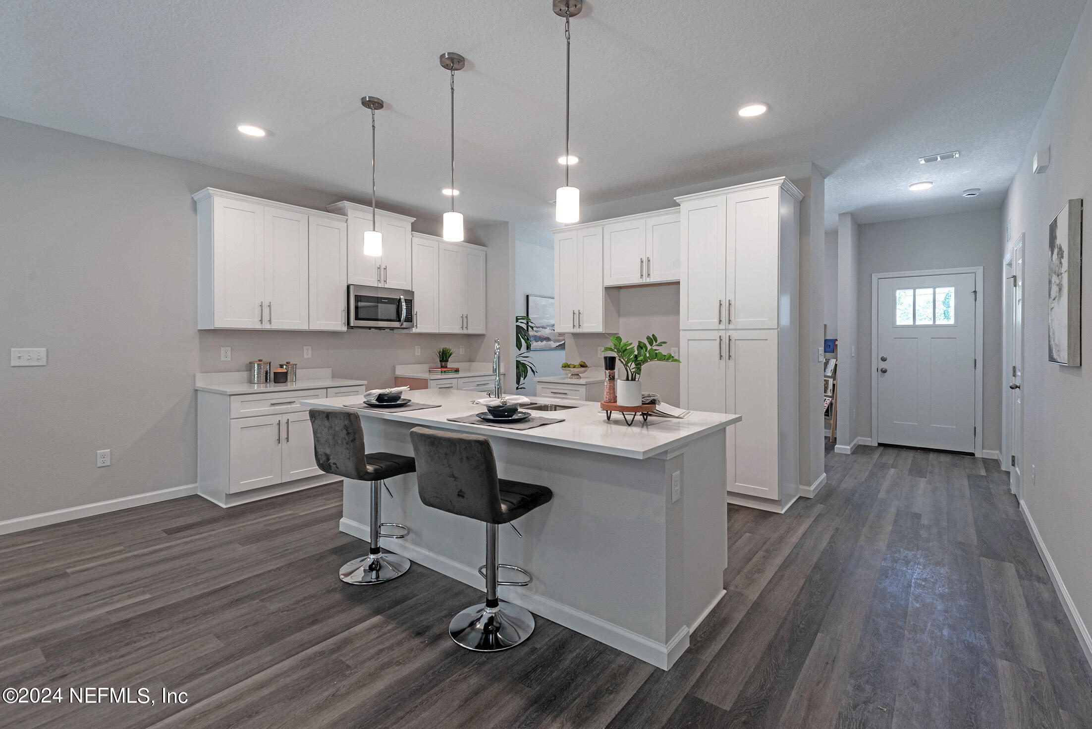 11814 Dunn Creek Road Jacksonville, FL 32218 - Photo 15 of 50 a kitchen with kitchen island stainless steel appliances a sink a stove a refrigerator and cabinets