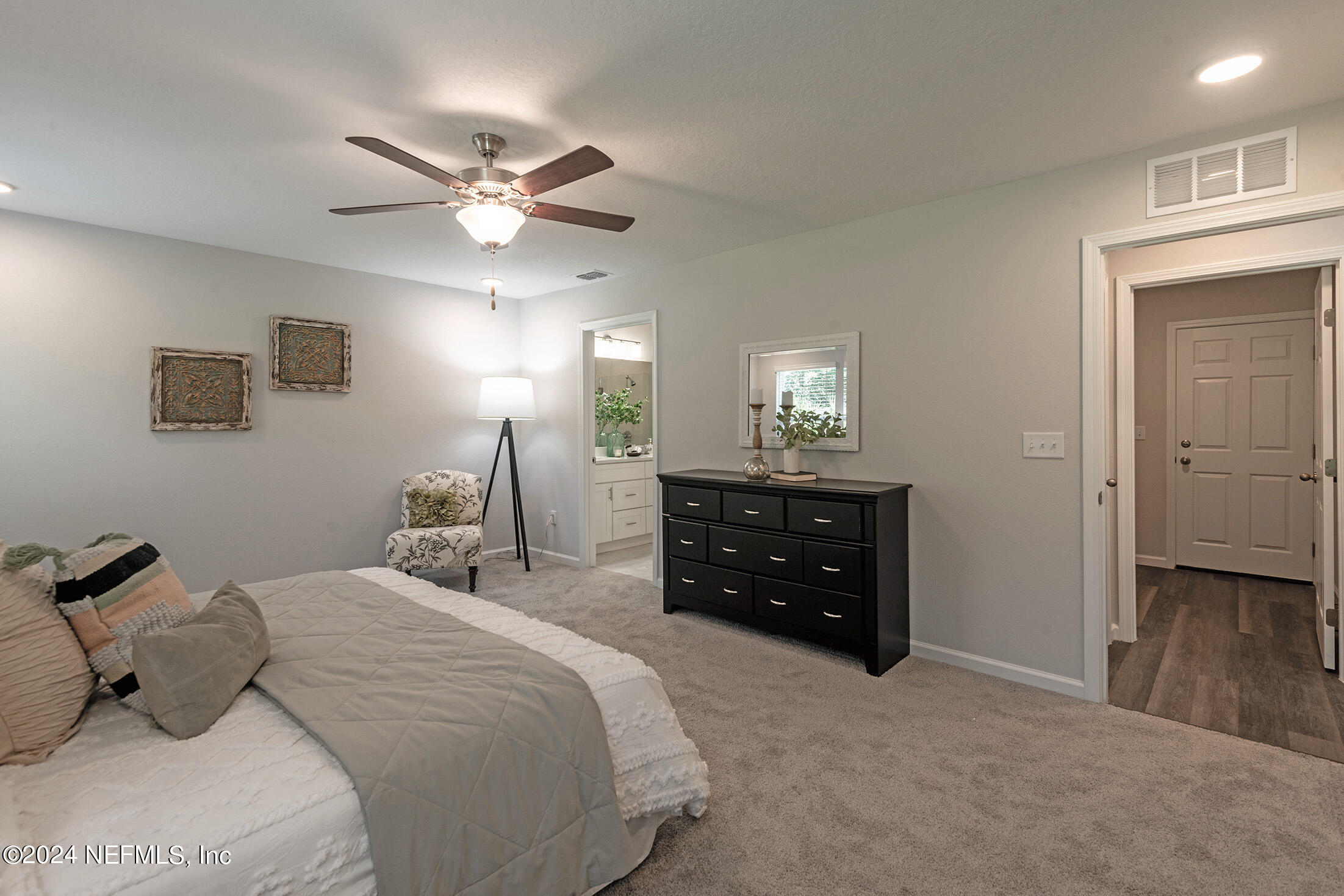 11814 Dunn Creek Road Jacksonville, FL 32218 - Photo 18 of 50 a bedroom with a bed and a chandelier