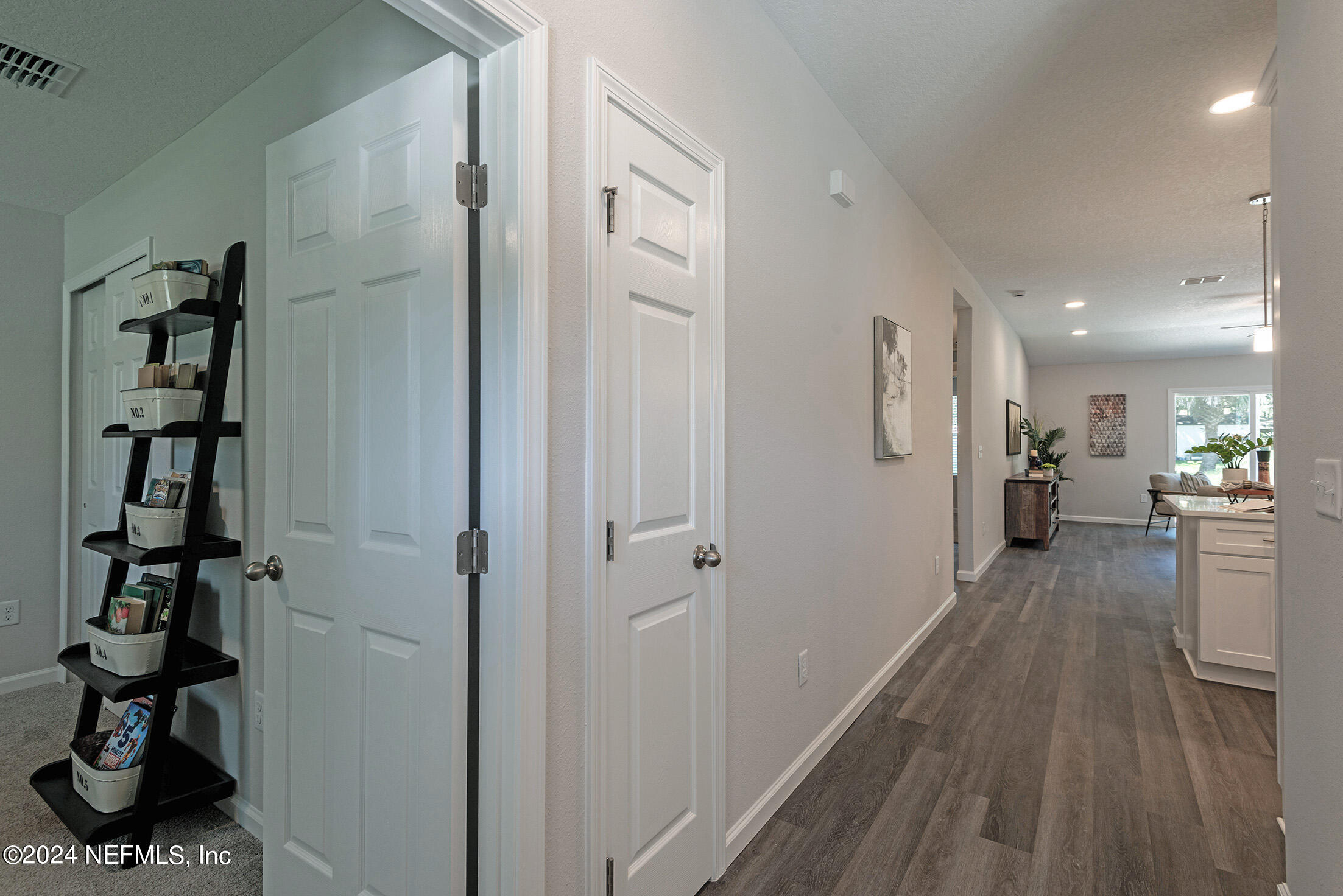 11814 Dunn Creek Road Jacksonville, FL 32218 - Photo 2 of 50 a view of a hallway with wooden floor and windows