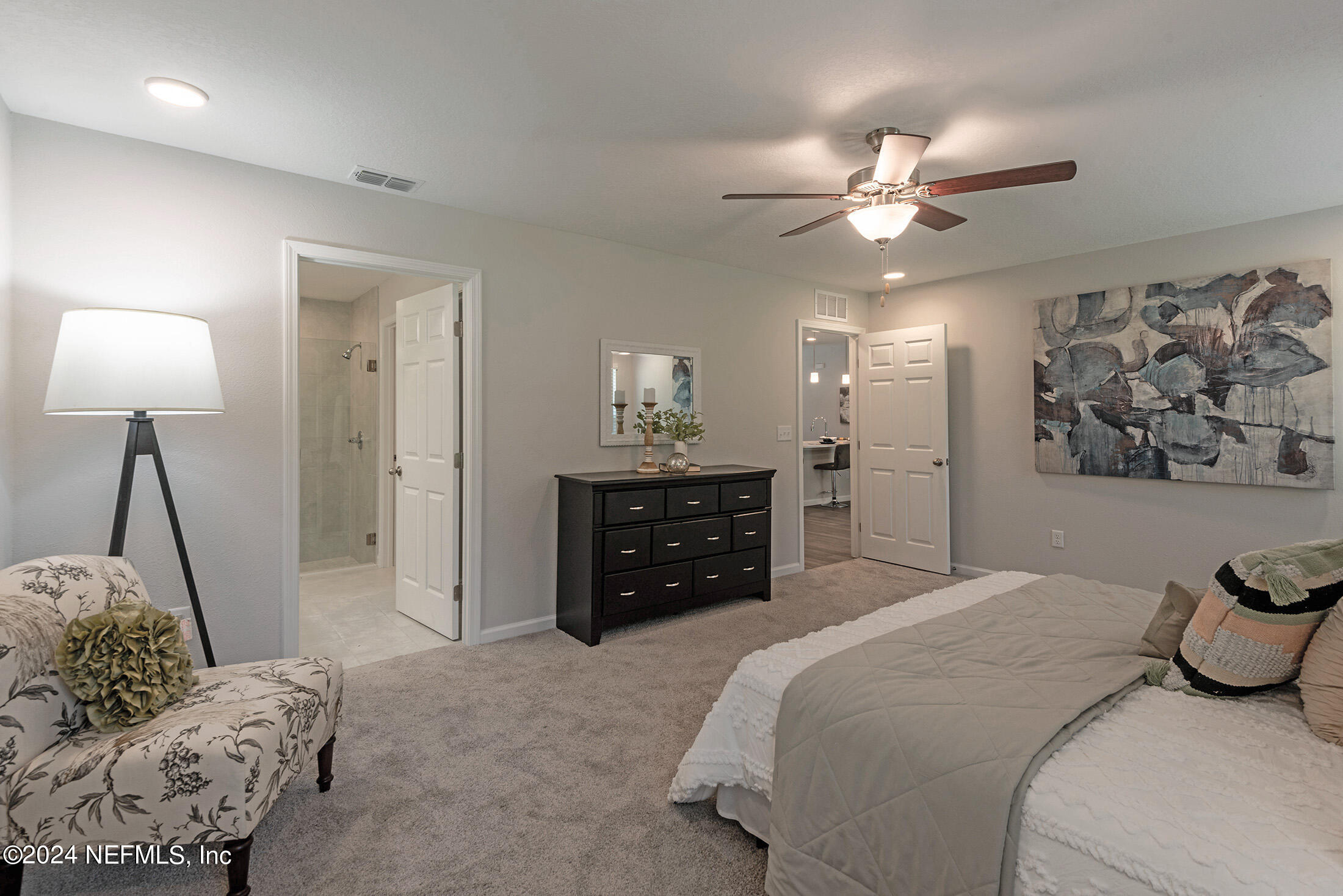 11814 Dunn Creek Road Jacksonville, FL 32218 - Photo 21 of 50 a bedroom with a bed and a chandelier