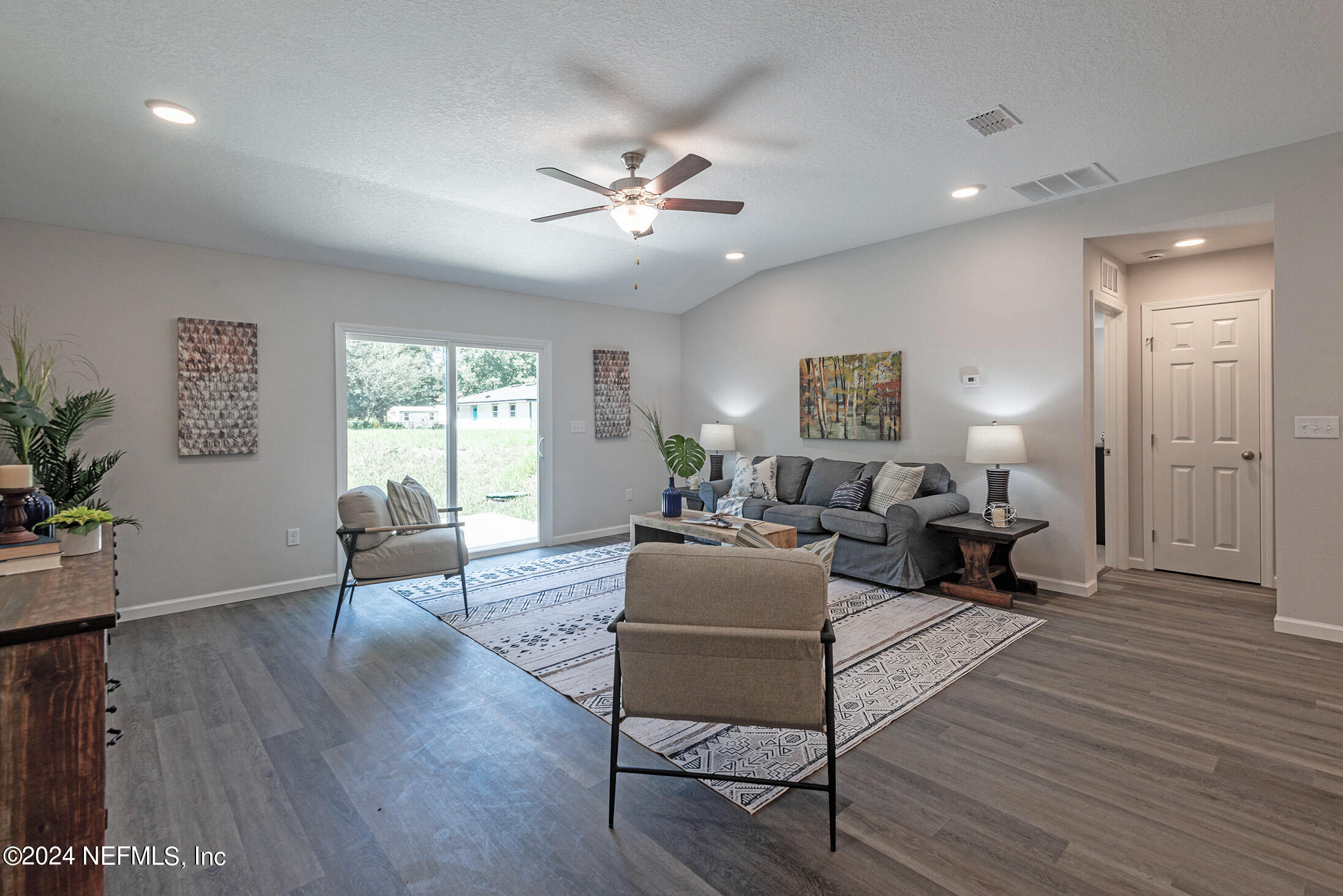 11814 Dunn Creek Road Jacksonville, FL 32218 - Photo 31 of 50 a living room with furniture and a wooden floor