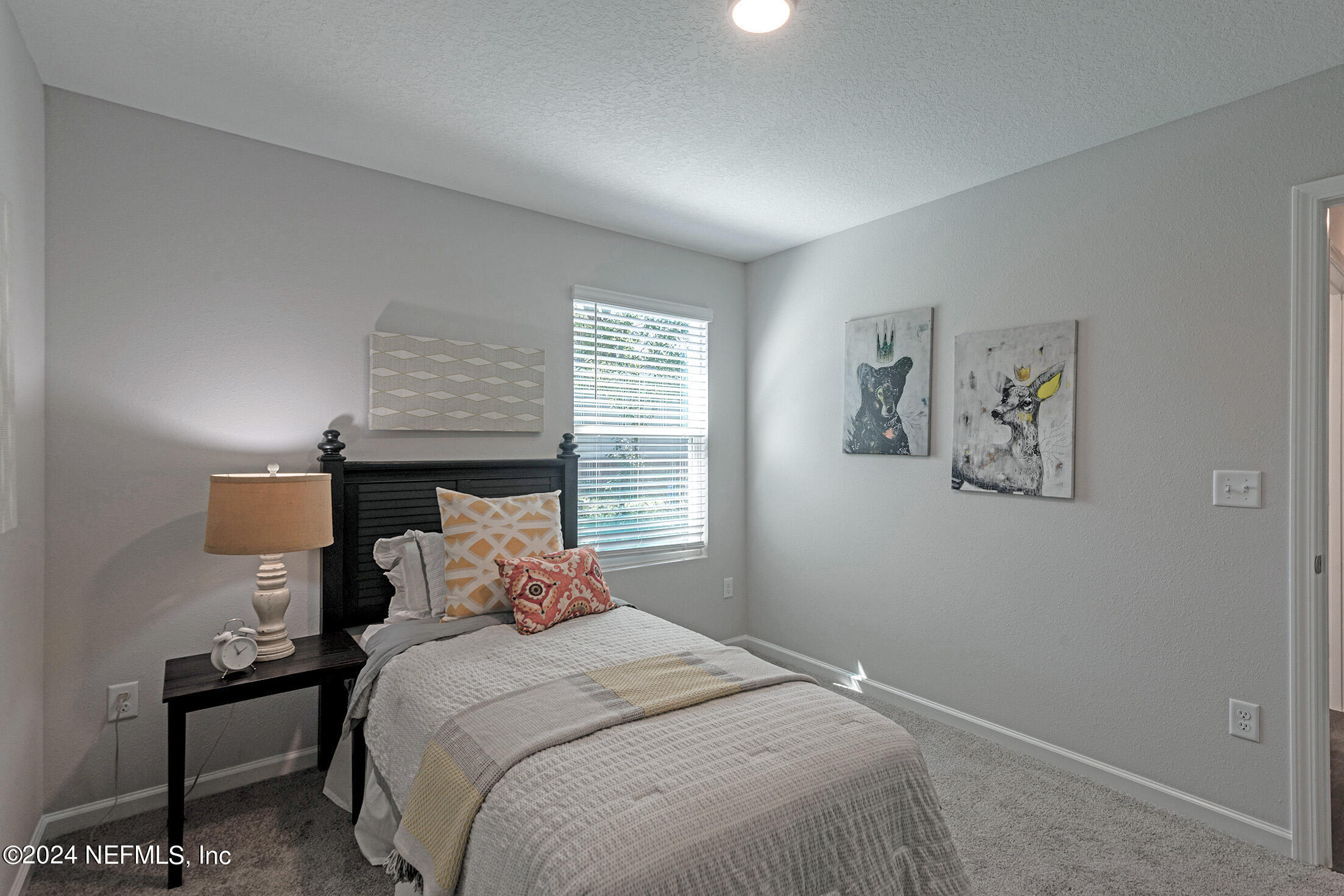 11814 Dunn Creek Road Jacksonville, FL 32218 - Photo 37 of 50 a bedroom with a bed and a night stand