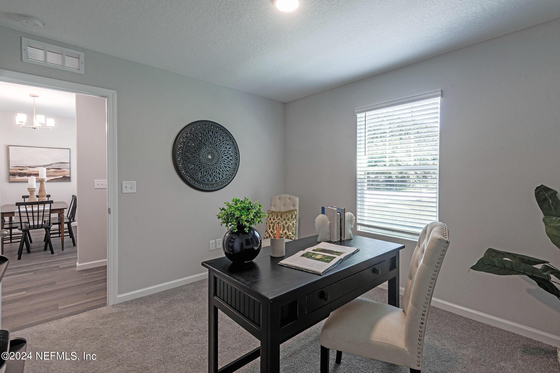 11814 Dunn Creek Road Jacksonville, FL 32218 - Photo 4 of 50 a view of a dining room with furniture and chandelier