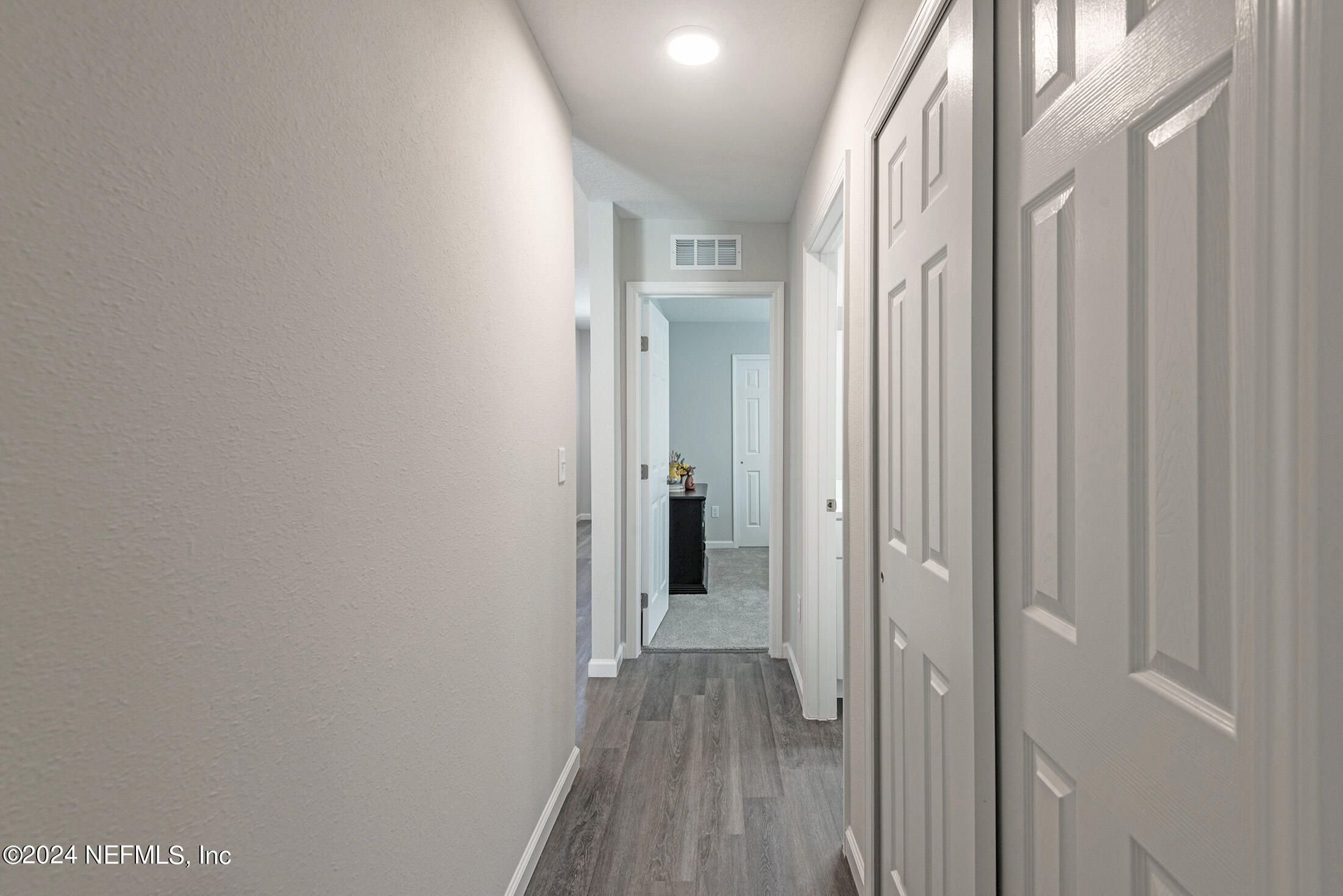 11814 Dunn Creek Road Jacksonville, FL 32218 - Photo 44 of 50 a view of a hallway with wooden floor and a bathroom