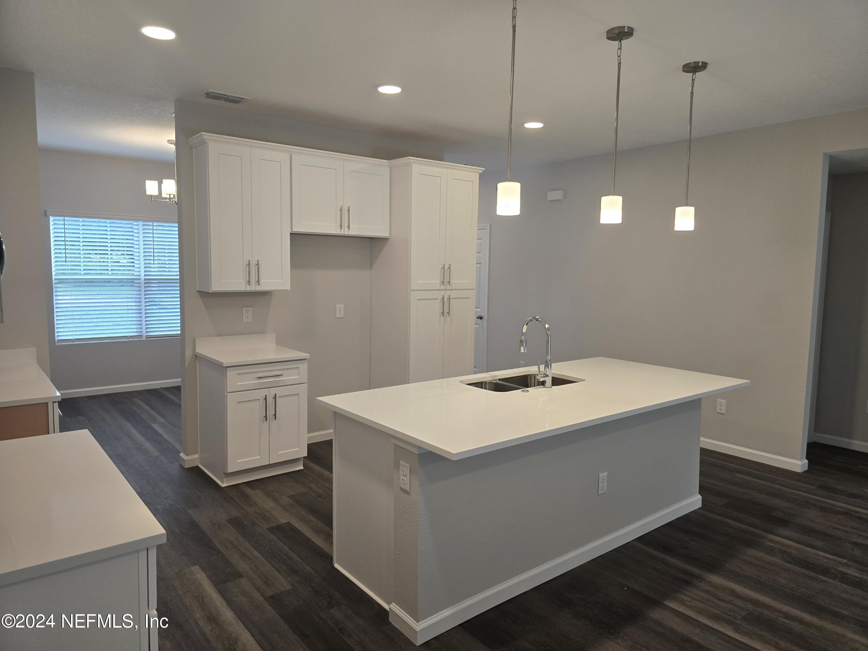 11814 Dunn Creek Road Jacksonville, FL 32218 - Photo 48 of 50 a kitchen with a sink and cabinets