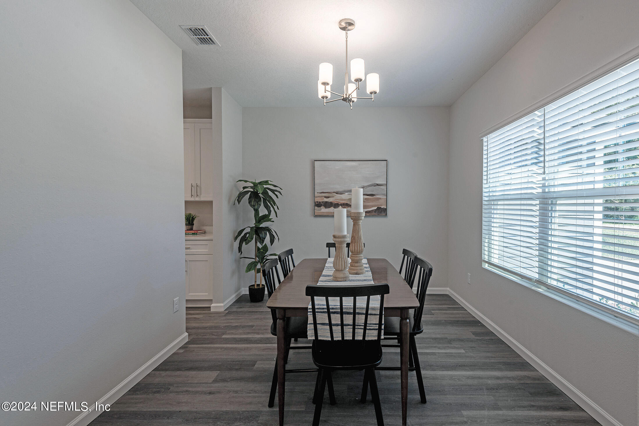 11814 Dunn Creek Road Jacksonville, FL 32218 - Photo 5 of 50 a view of a dining room with furniture and chandelier