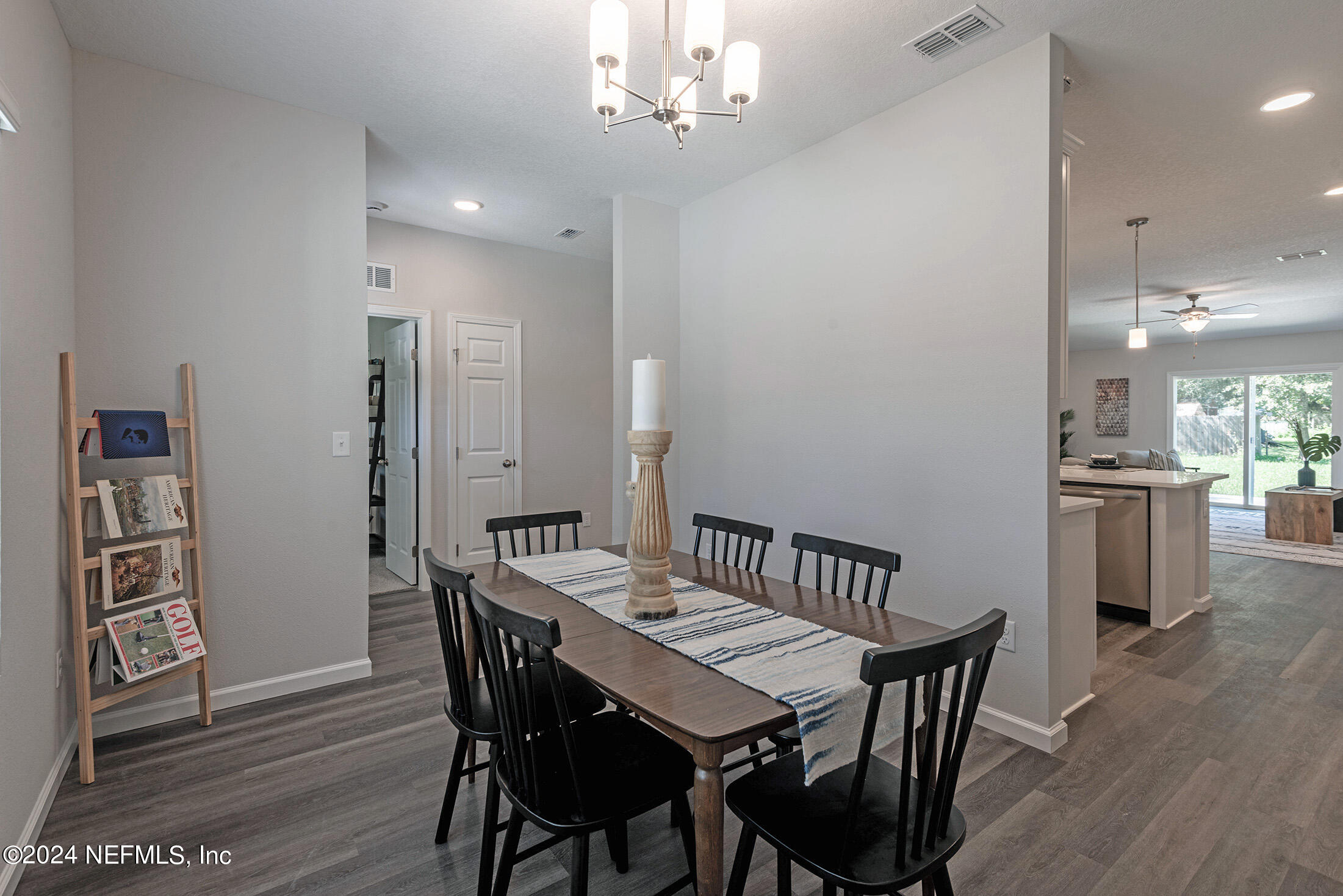 11814 Dunn Creek Road Jacksonville, FL 32218 - Photo 7 of 50 a view of a dining room with furniture and wooden floor