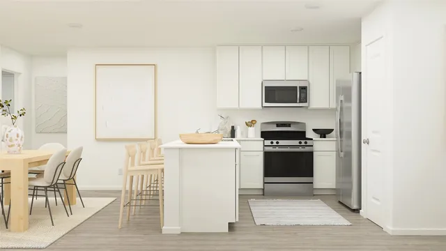 a kitchen with a stove a sink and a microwave