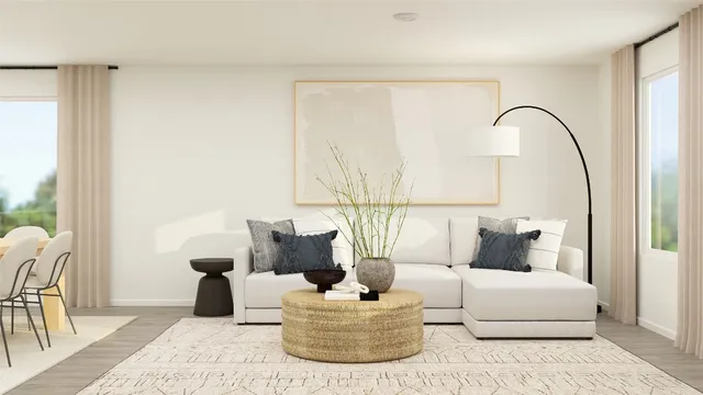 a living room with furniture and a potted plant