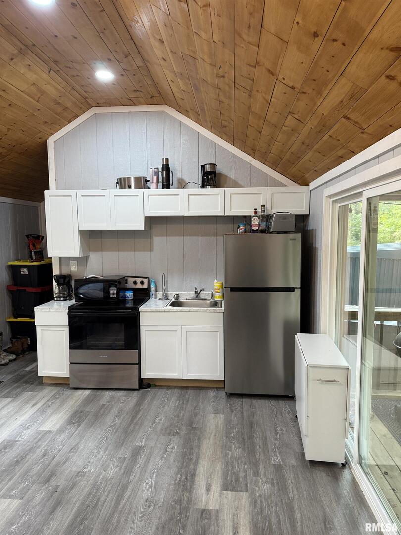0 North Shawnee Hills Road Equality, IL 62934 - Photo 4 of 22 a kitchen with a white stove top oven and refrigerator