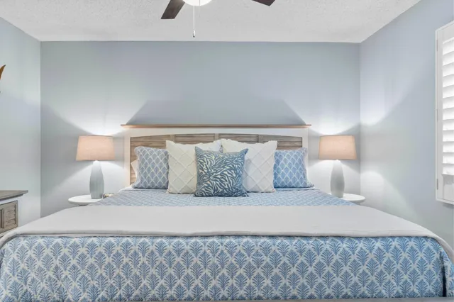 a bedroom with a bed and a lamp