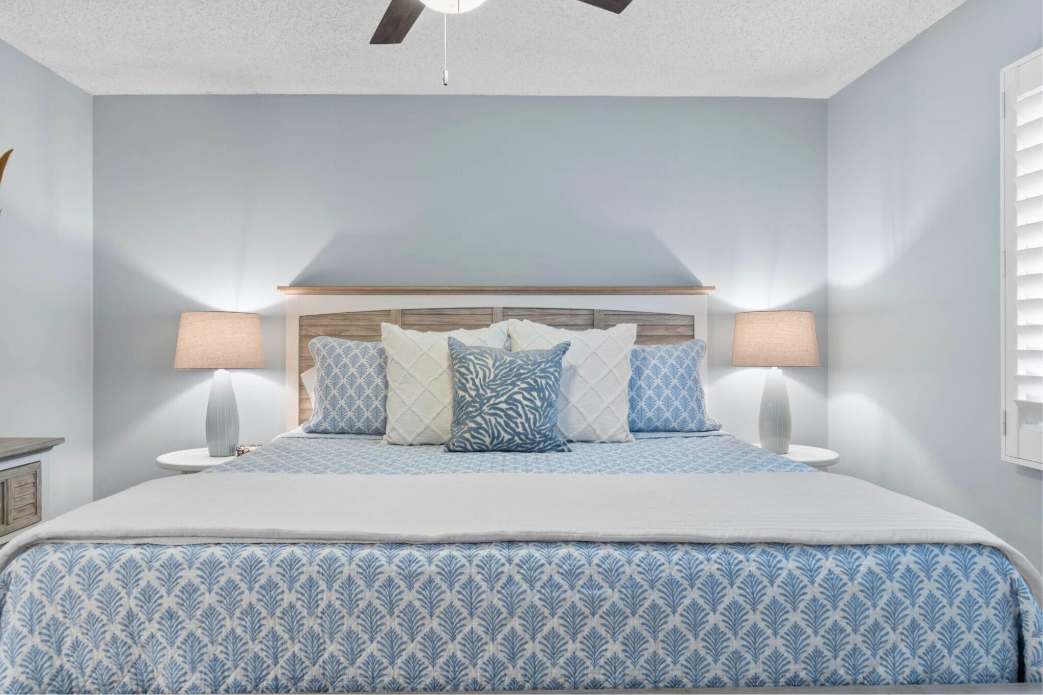 23223 Front Beach Road, Unit 308 Panama City Beach, FL 32413 - Photo 12 of 18 a bedroom with a bed and a lamp