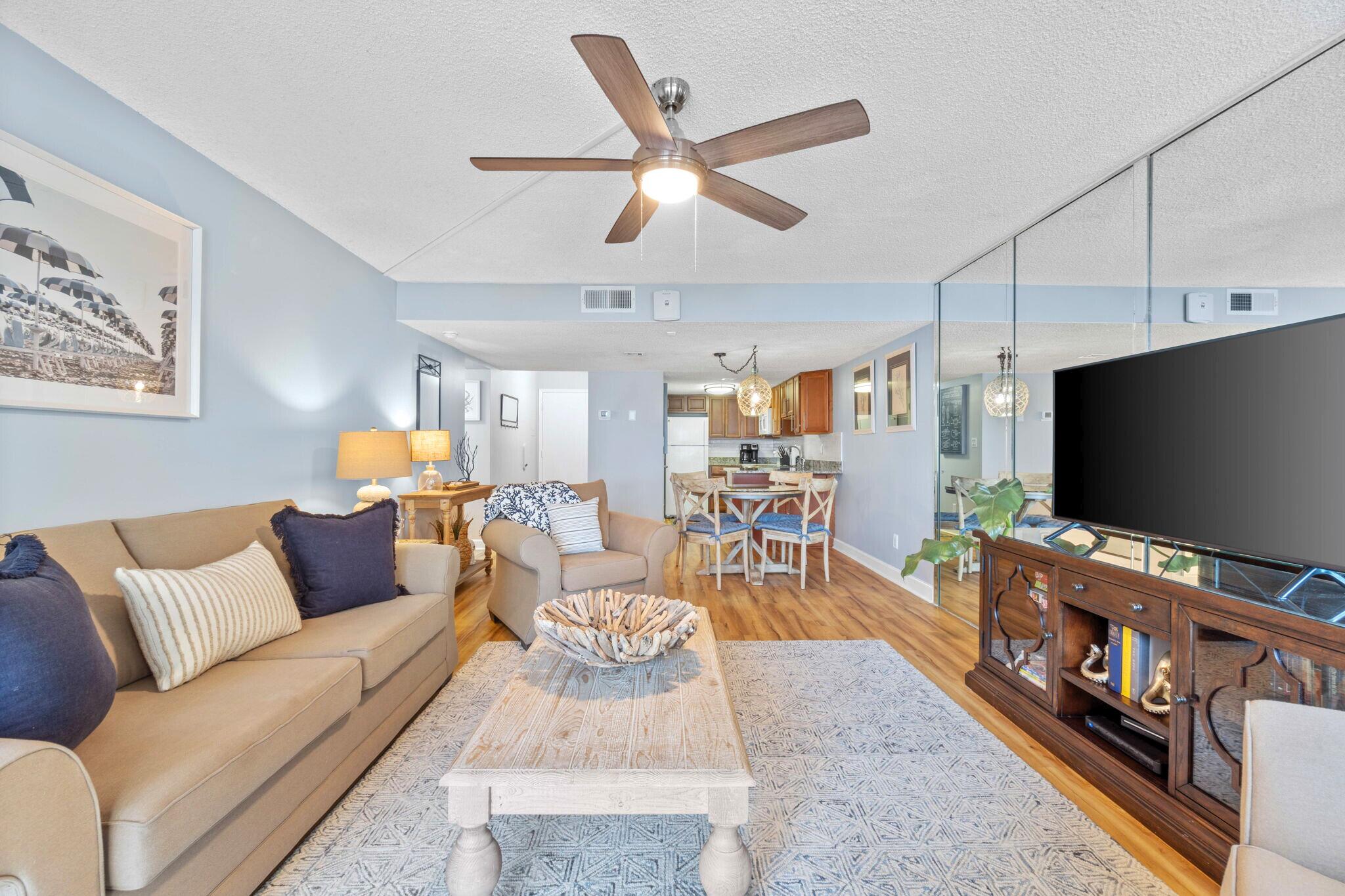 23223 Front Beach Road, Unit 308 Panama City Beach, FL 32413 - Photo 13 of 18 a living room with furniture and a flat screen tv