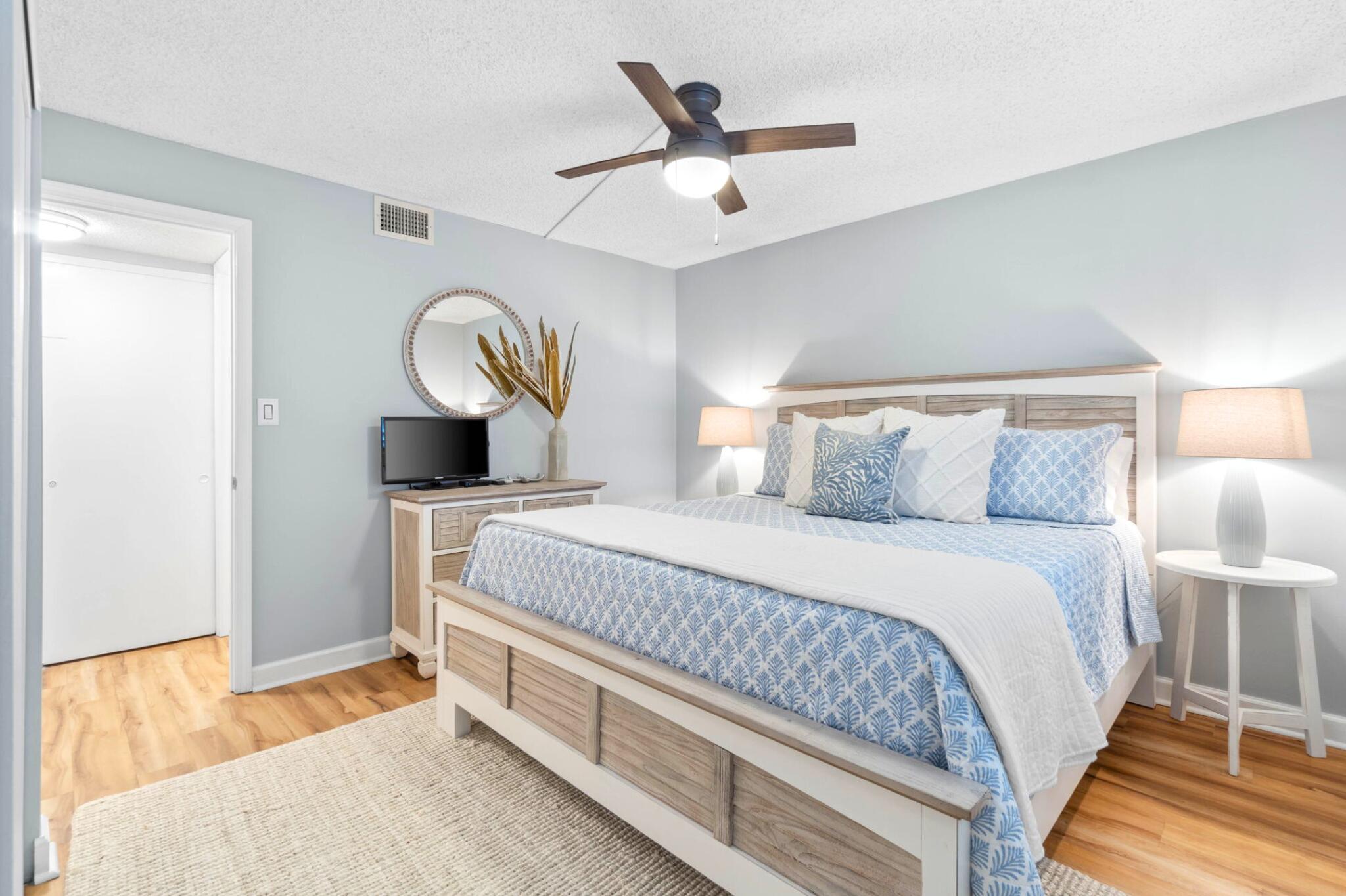 23223 Front Beach Road, Unit 308 Panama City Beach, FL 32413 - Photo 18 of 18 a bedroom with a bed and a lamp