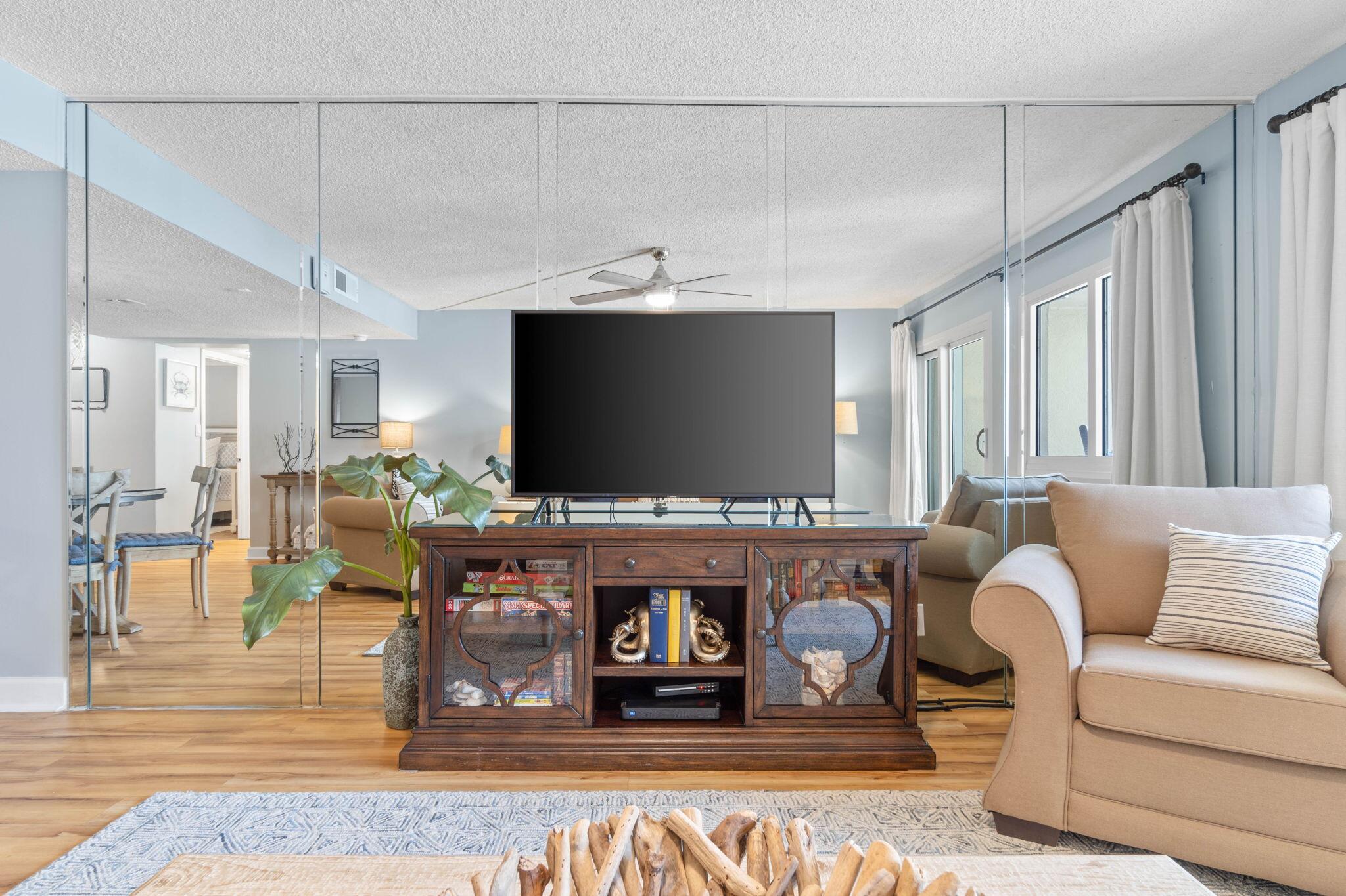 23223 Front Beach Road, Unit 308 Panama City Beach, FL 32413 - Photo 7 of 18 a living room with furniture and a flat screen tv