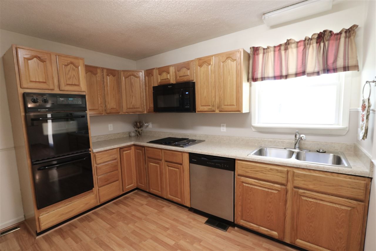 2003 Shutterlee Mill Road Staunton, VA 24401 - Photo 17 of 45 a kitchen with granite countertop a refrigerator stove top oven and sink