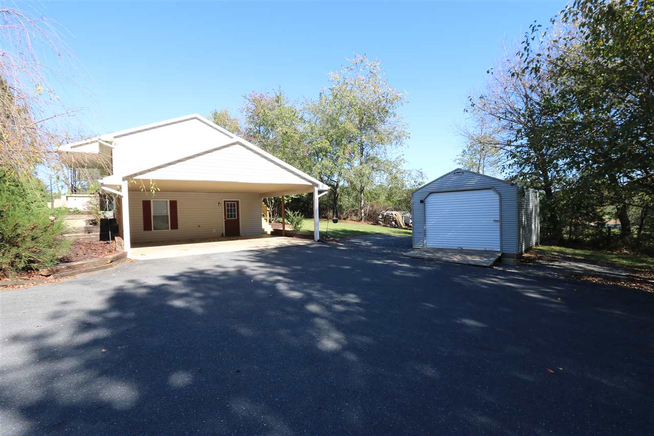 2003 Shutterlee Mill Road Staunton, VA 24401 - Photo 5 of 45 a front view of a house with a yard and garage