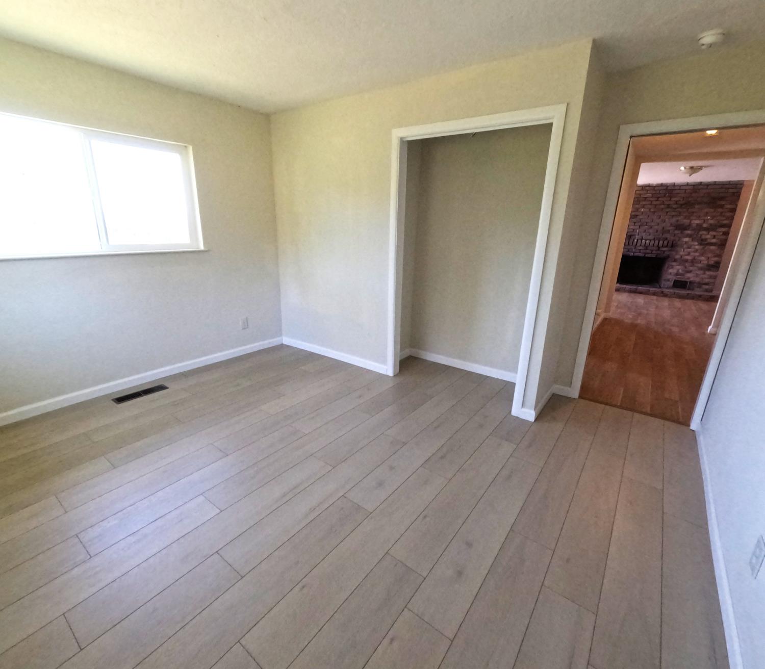 21665 Manton School Road Manton, CA 96059 - Photo 16 of 30 an empty room with wooden floor and windows