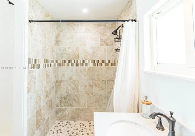 a view of a hallway with wooden floor and furniture
