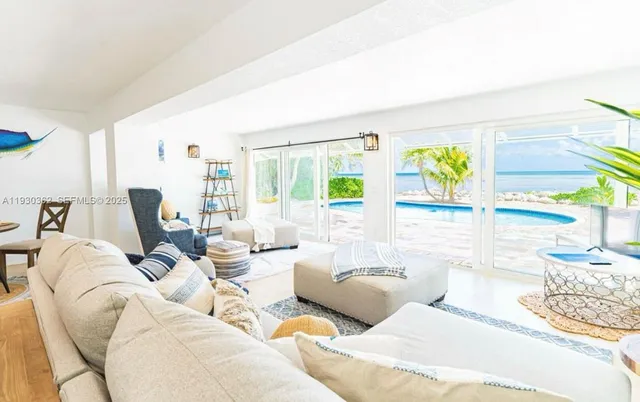 a kitchen with kitchen island a stove a table and chairs in it