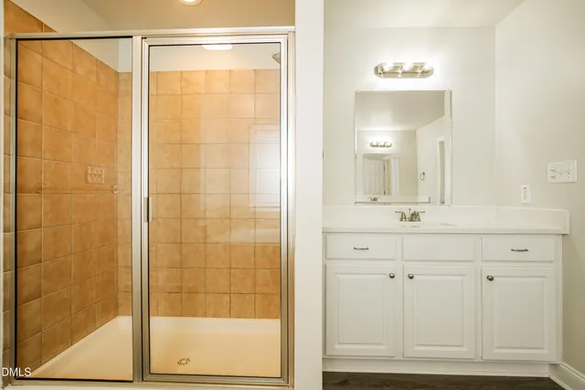 a bathroom with a tub sink and mirror