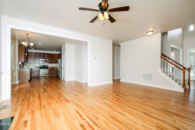 a view of a kitchen with wooden floor and a sink