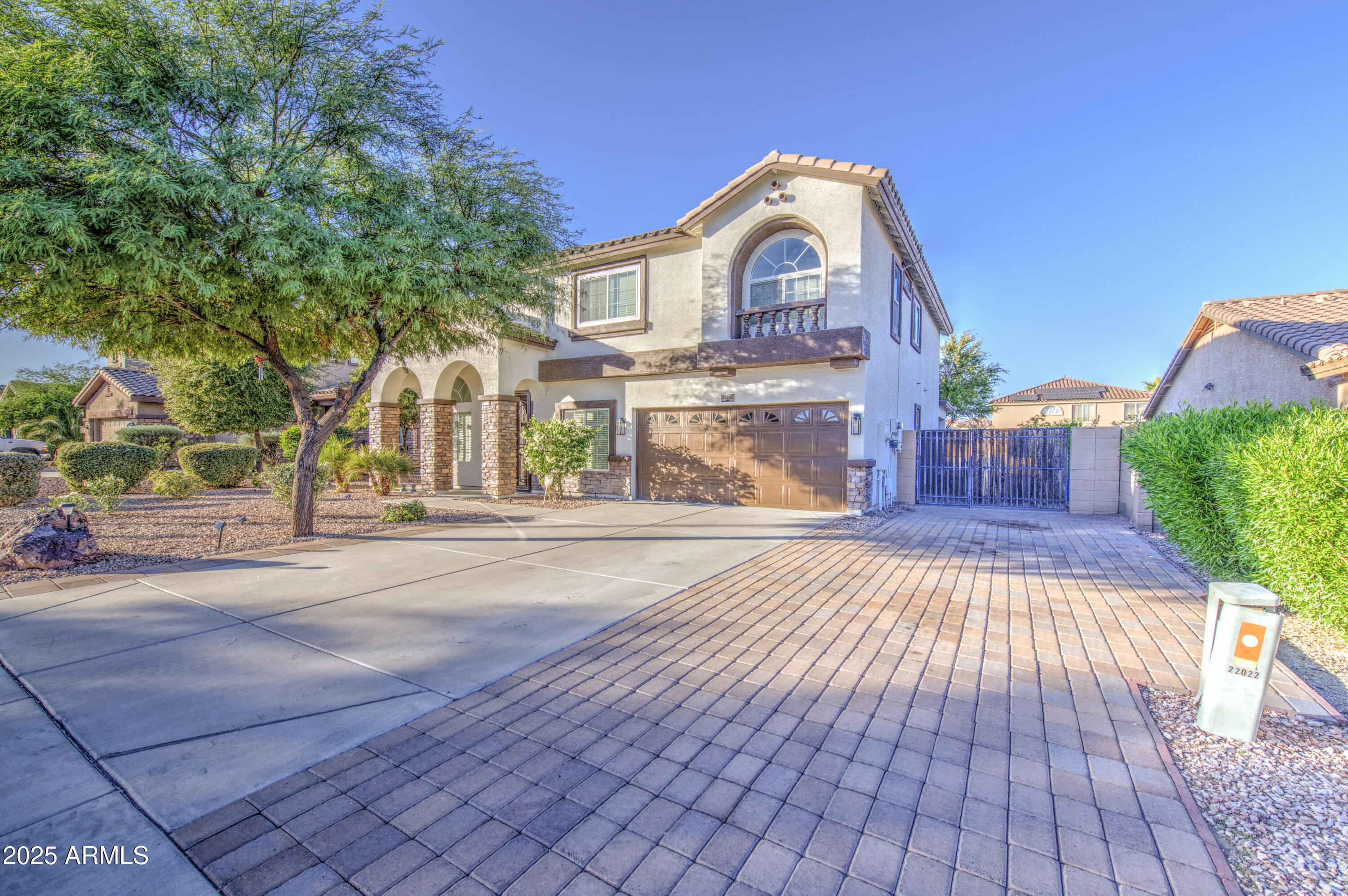 22022 West Moonlight Path Buckeye, AZ 85326 - Photo 1 of 49 a front view of a house with a yard