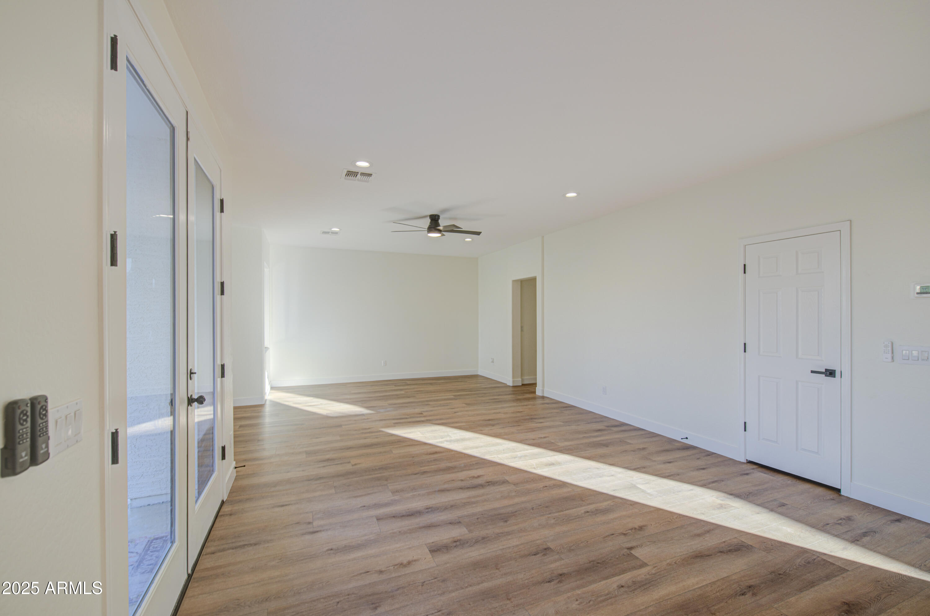 22022 West Moonlight Path Buckeye, AZ 85326 - Photo 14 of 49 a view of an empty room with wooden floor