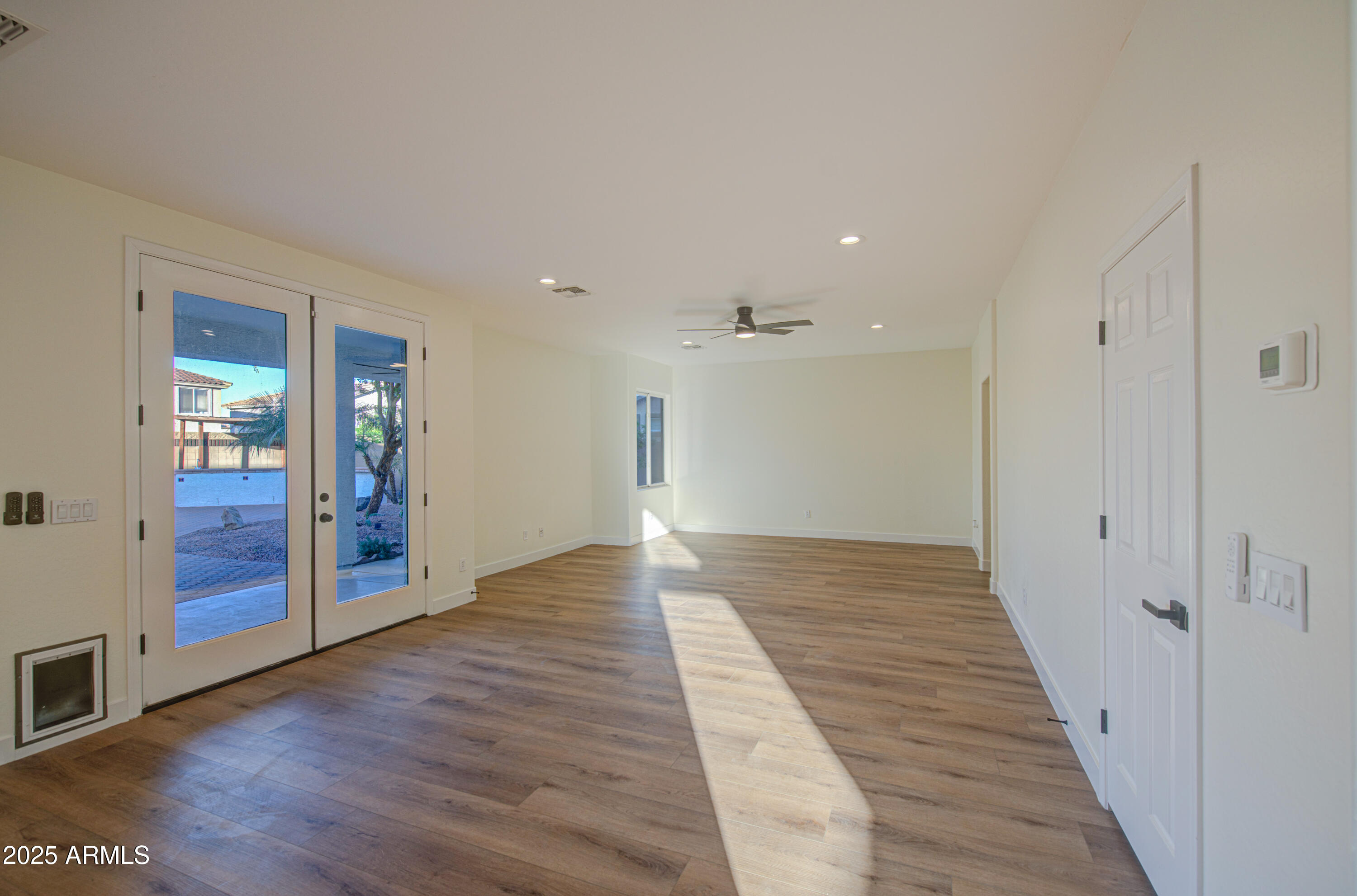 22022 West Moonlight Path Buckeye, AZ 85326 - Photo 15 of 49 a view of a hallway with wooden floor