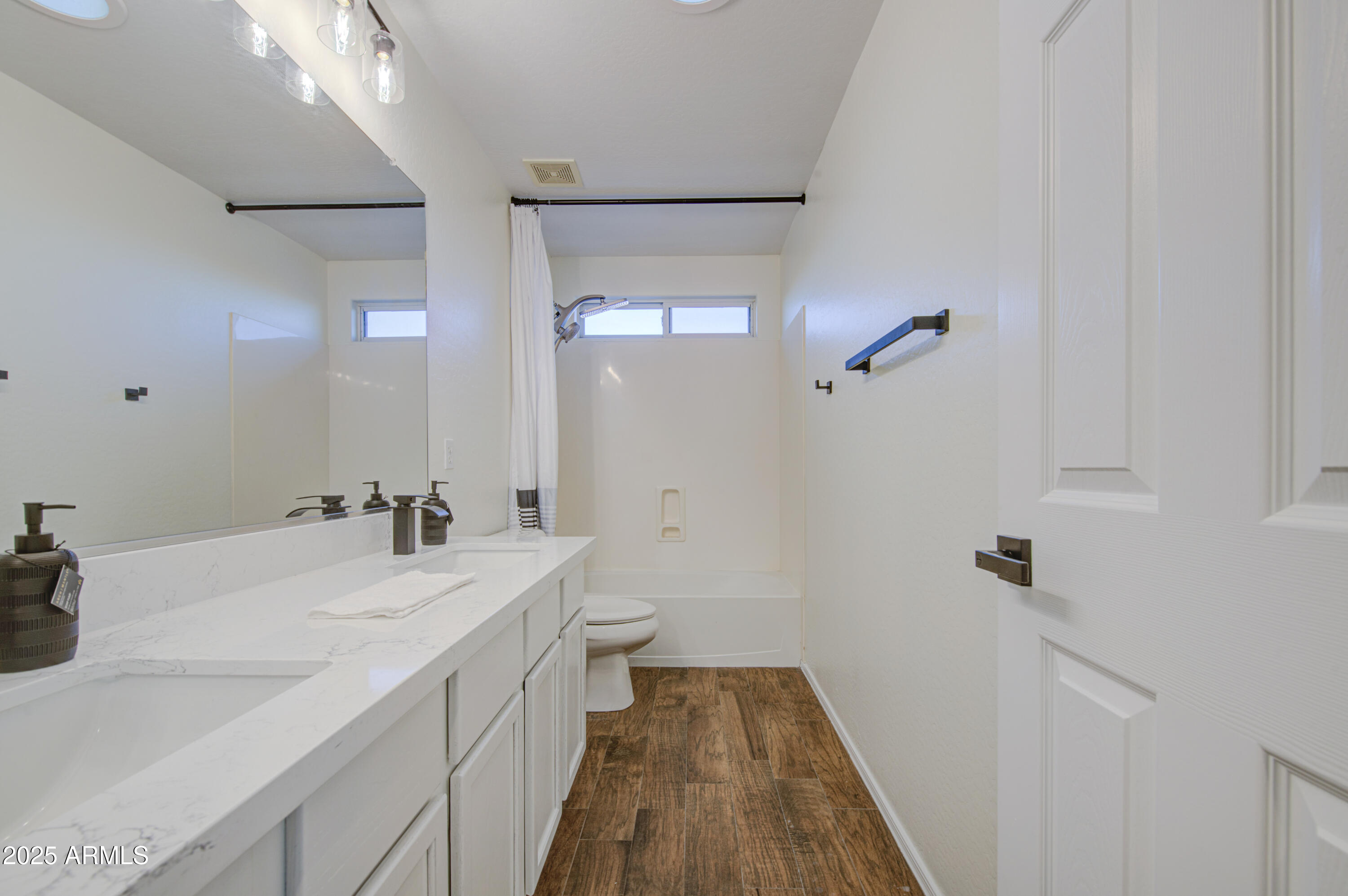 22022 West Moonlight Path Buckeye, AZ 85326 - Photo 22 of 49 a bathroom with a sink a toilet and a mirror