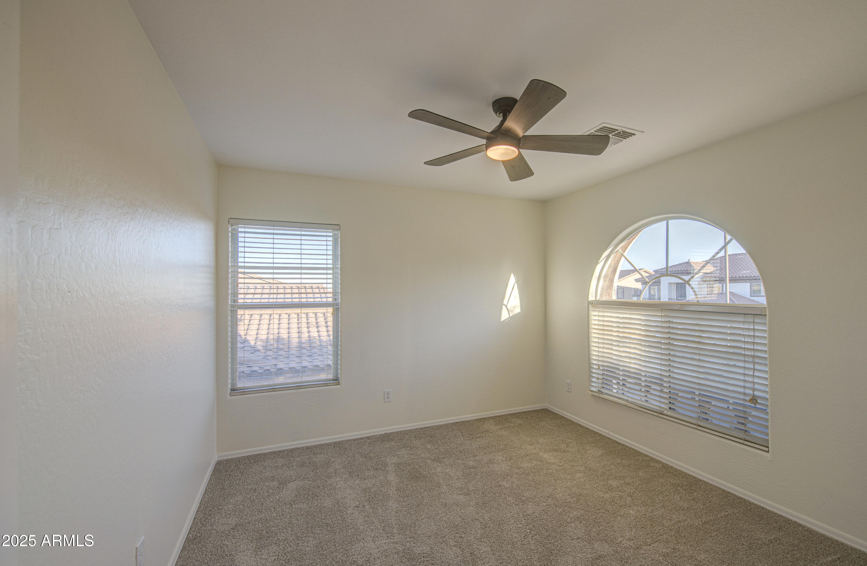 22022 West Moonlight Path Buckeye, AZ 85326 - Photo 27 of 49 a view of empty room with windows