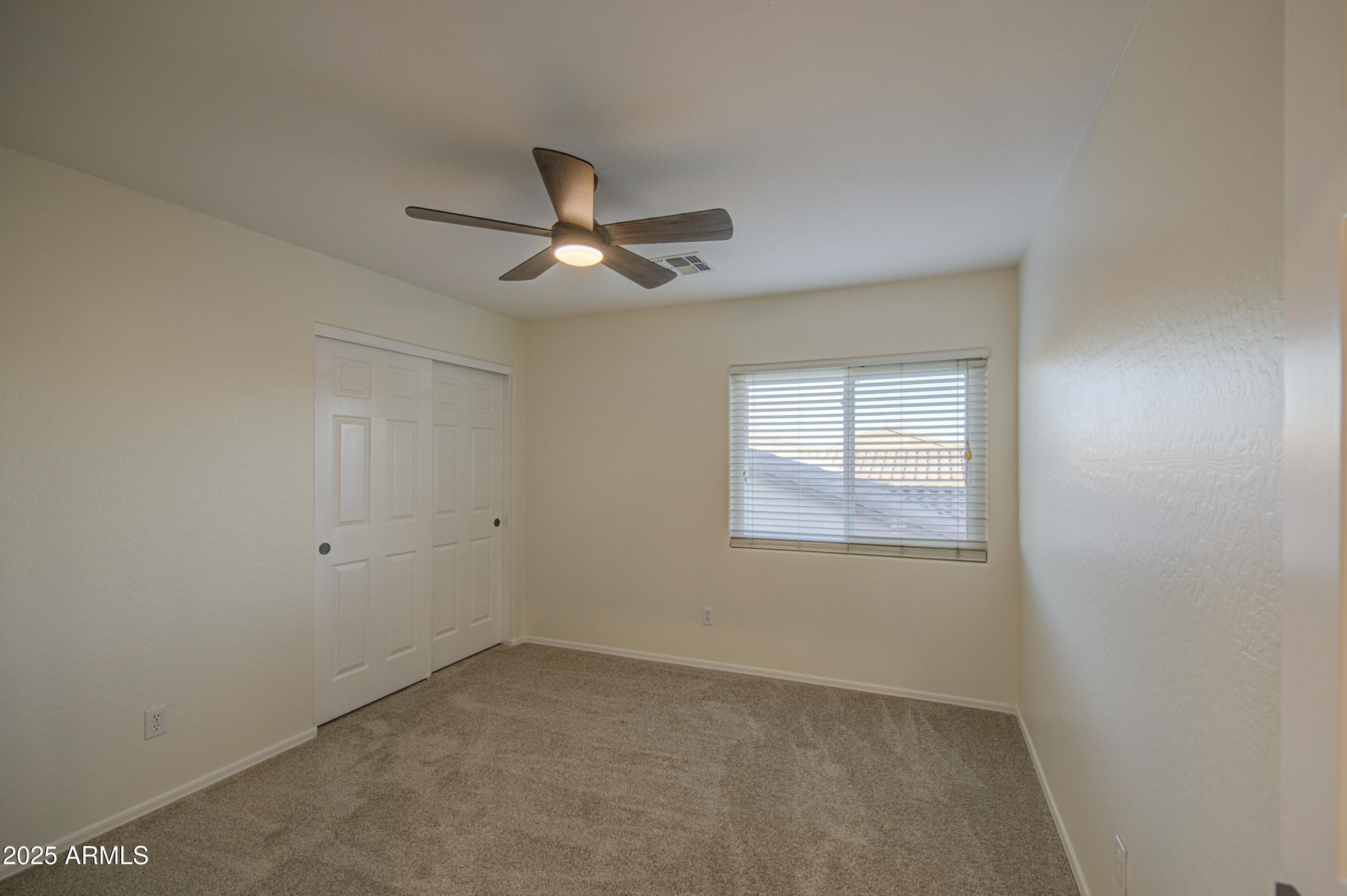 22022 West Moonlight Path Buckeye, AZ 85326 - Photo 29 of 49 an empty room with a window and a ceiling fan