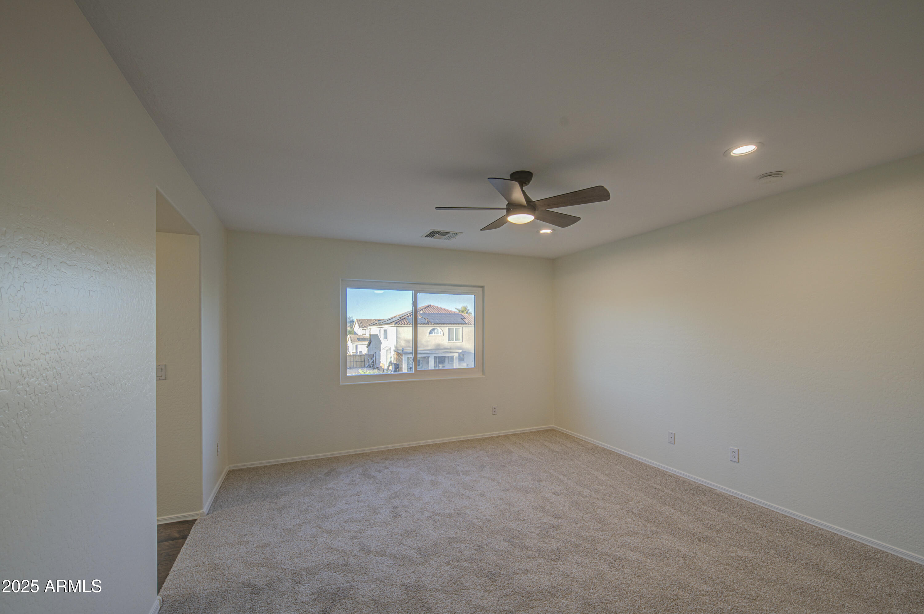 22022 West Moonlight Path Buckeye, AZ 85326 - Photo 38 of 49 an empty room with windows and fan