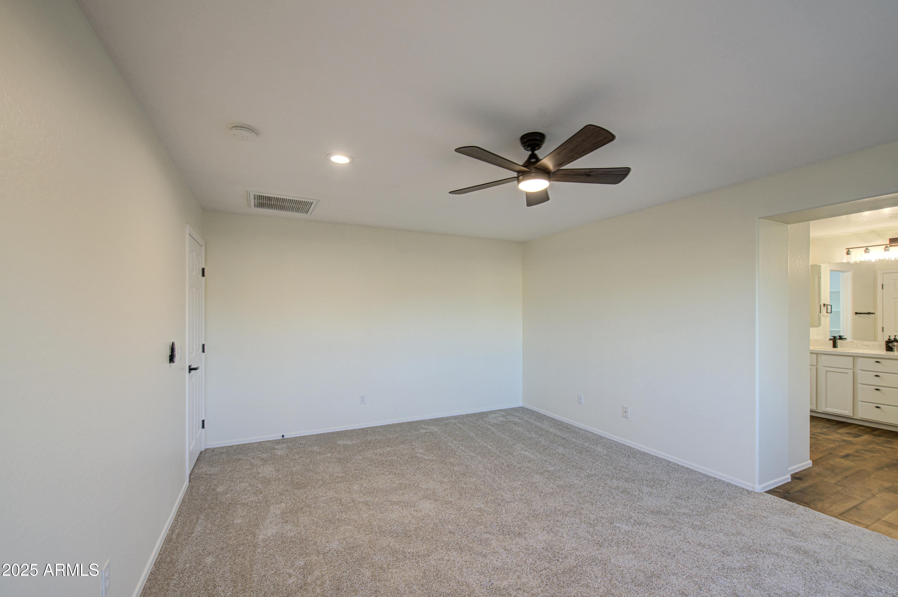 22022 West Moonlight Path Buckeye, AZ 85326 - Photo 39 of 49 an empty room with a ceiling fan and a window
