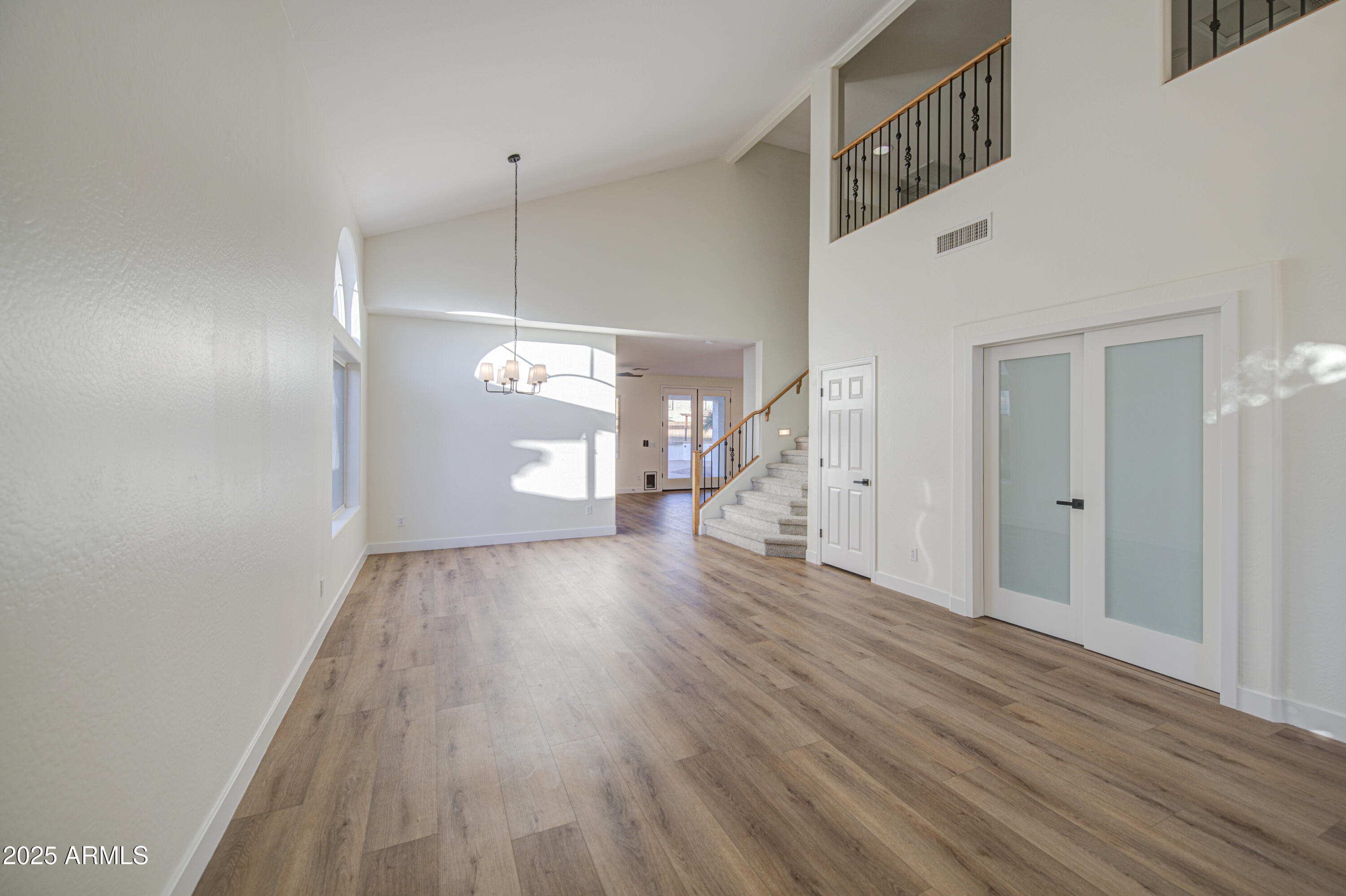 22022 West Moonlight Path Buckeye, AZ 85326 - Photo 4 of 49 a view of a room with wooden floor and staircase