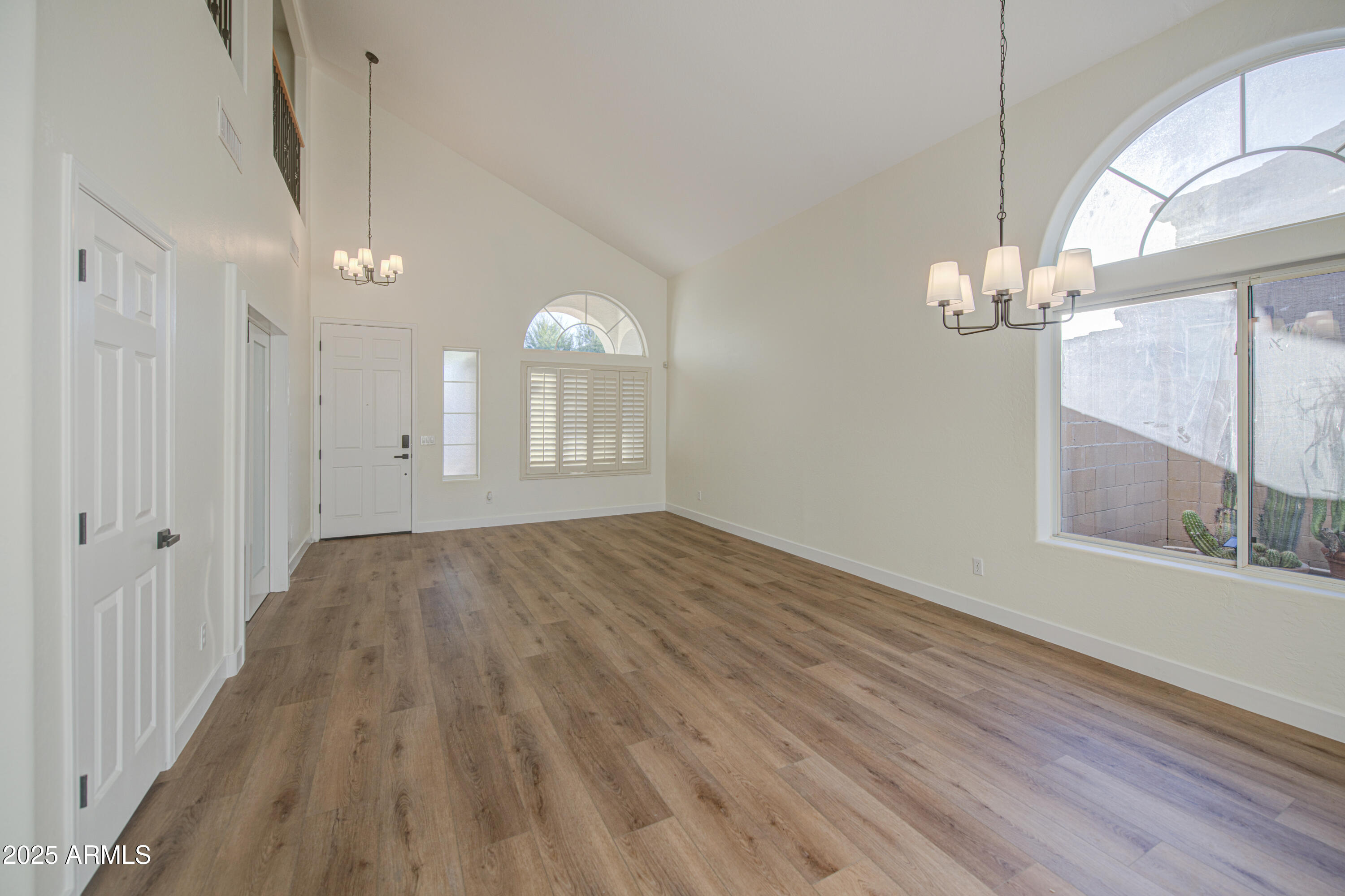 22022 West Moonlight Path Buckeye, AZ 85326 - Photo 5 of 49 a view of a room with wooden floor and chandelier