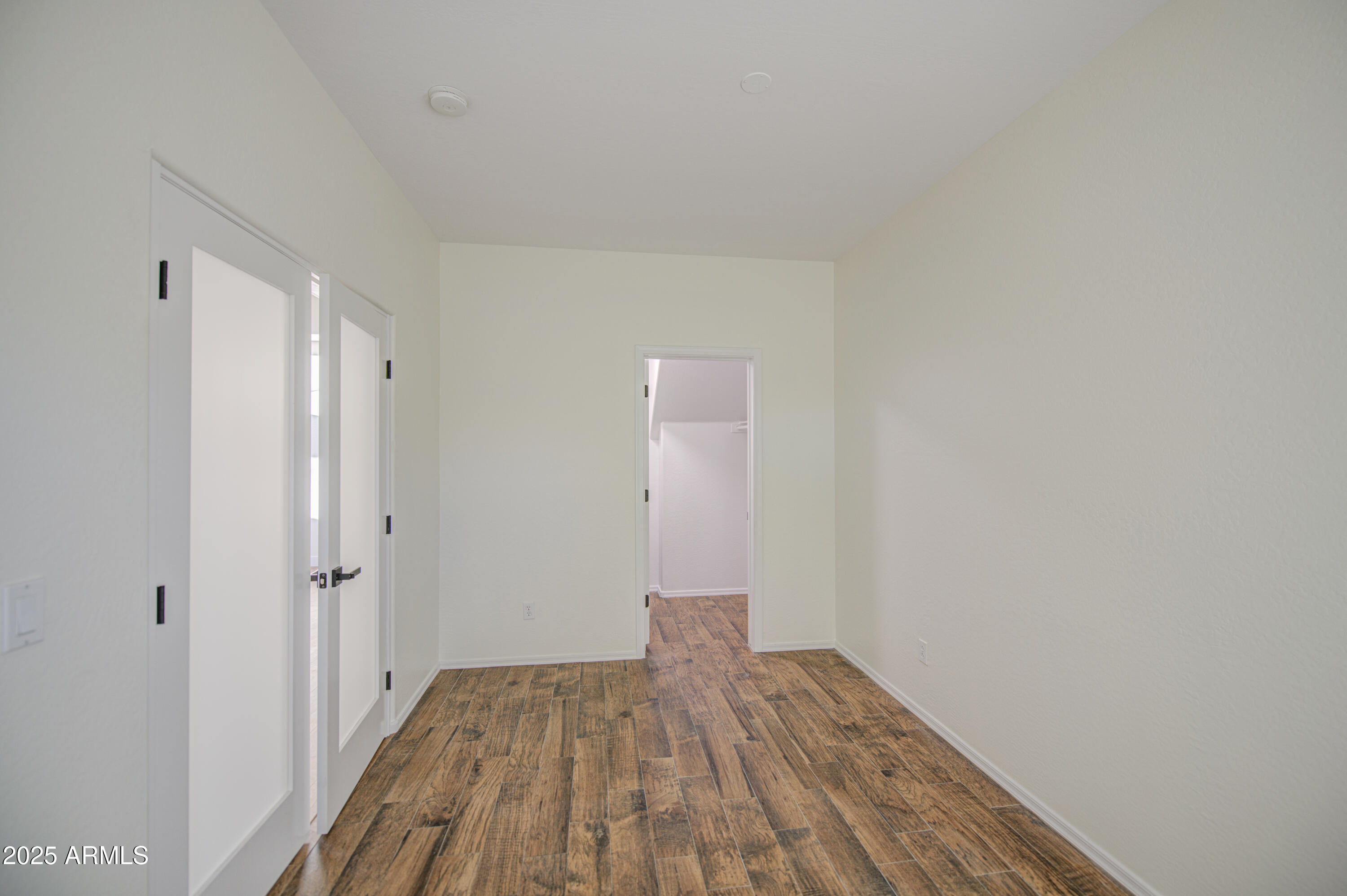 22022 West Moonlight Path Buckeye, AZ 85326 - Photo 8 of 49 a view of a room with wooden floor and a bathroom