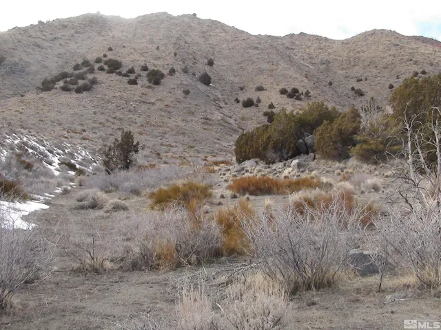 a view of mountain with beach and background