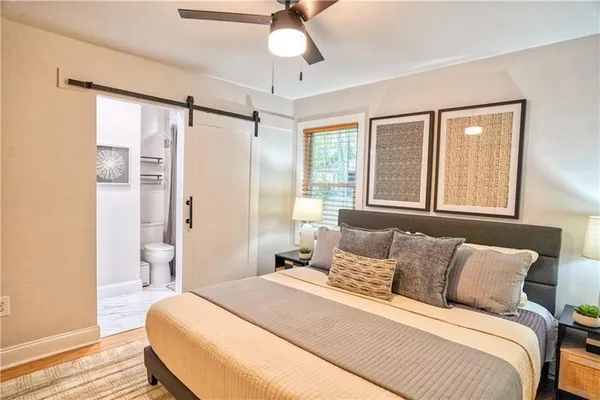 a bedroom with a bed and a chandelier