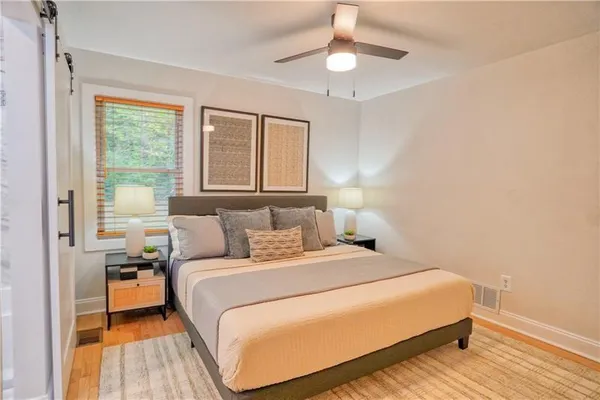 a bedroom with a large bed and a chandelier