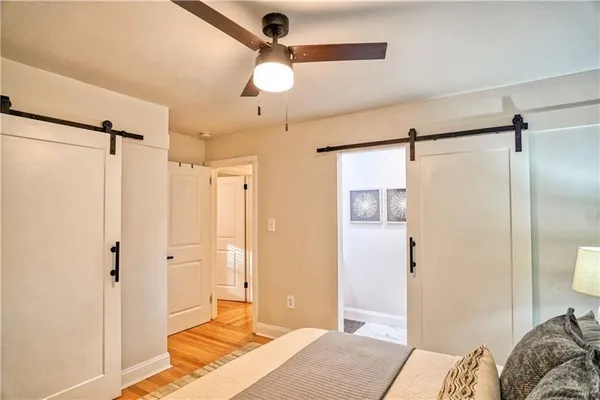 a bedroom with a bed and a chandelier fan
