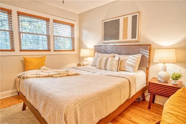 a bedroom with a bed and wooden floor