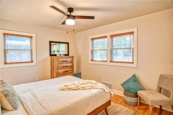 a bedroom with a bed dresser and a window