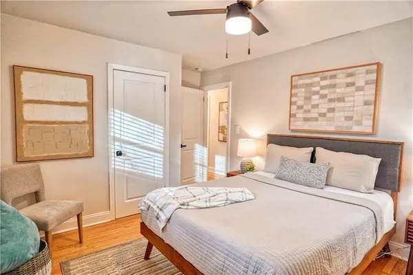 a bedroom with a bed and a chair