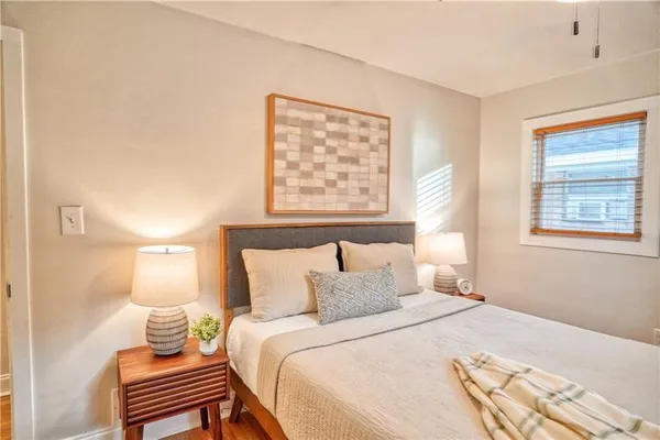 a bedroom with a bed and a lamp