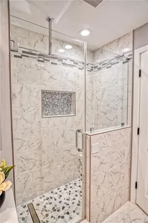 a bathroom with a shower and a glass door shower