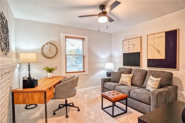 a living room with furniture a chandelier and a window