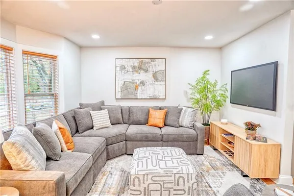 a living room with furniture and a flat screen tv