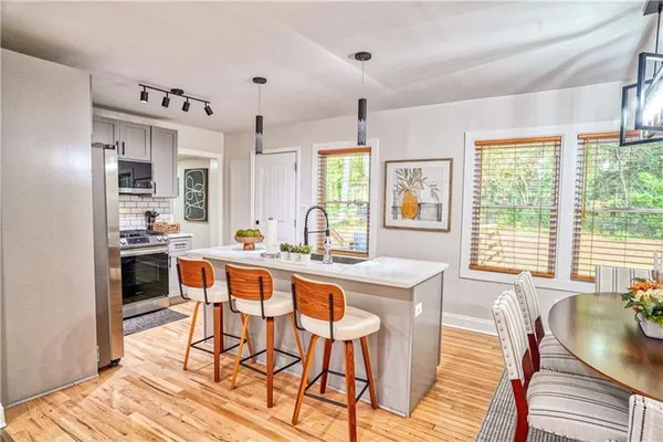 a large kitchen with a table and chairs in it