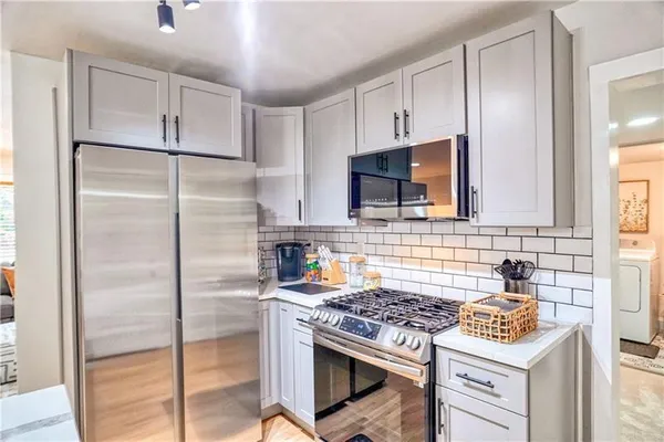 a kitchen with a stove and a refrigerator